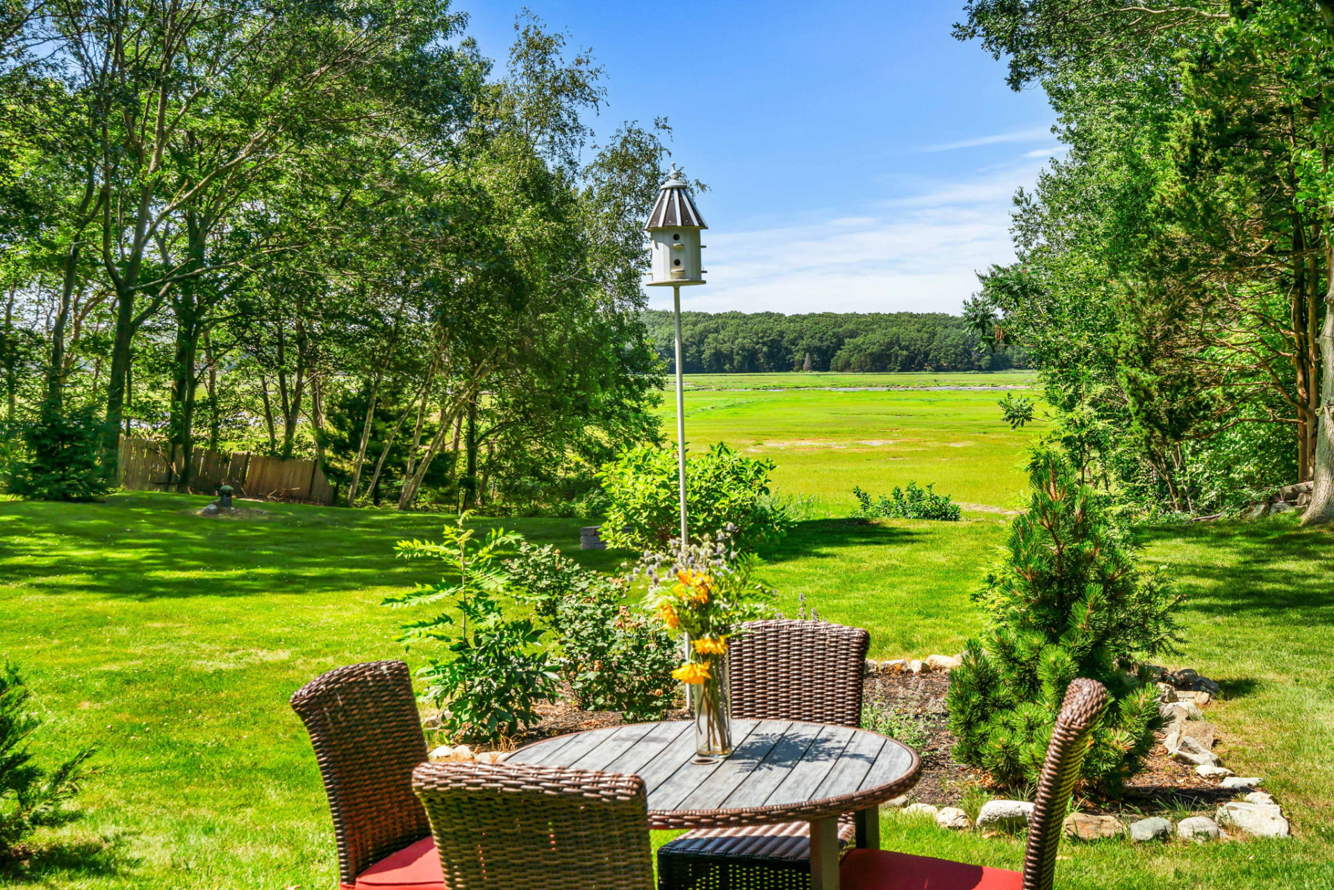 Wicker dining set on the lawn overlooking the Parker River marsh