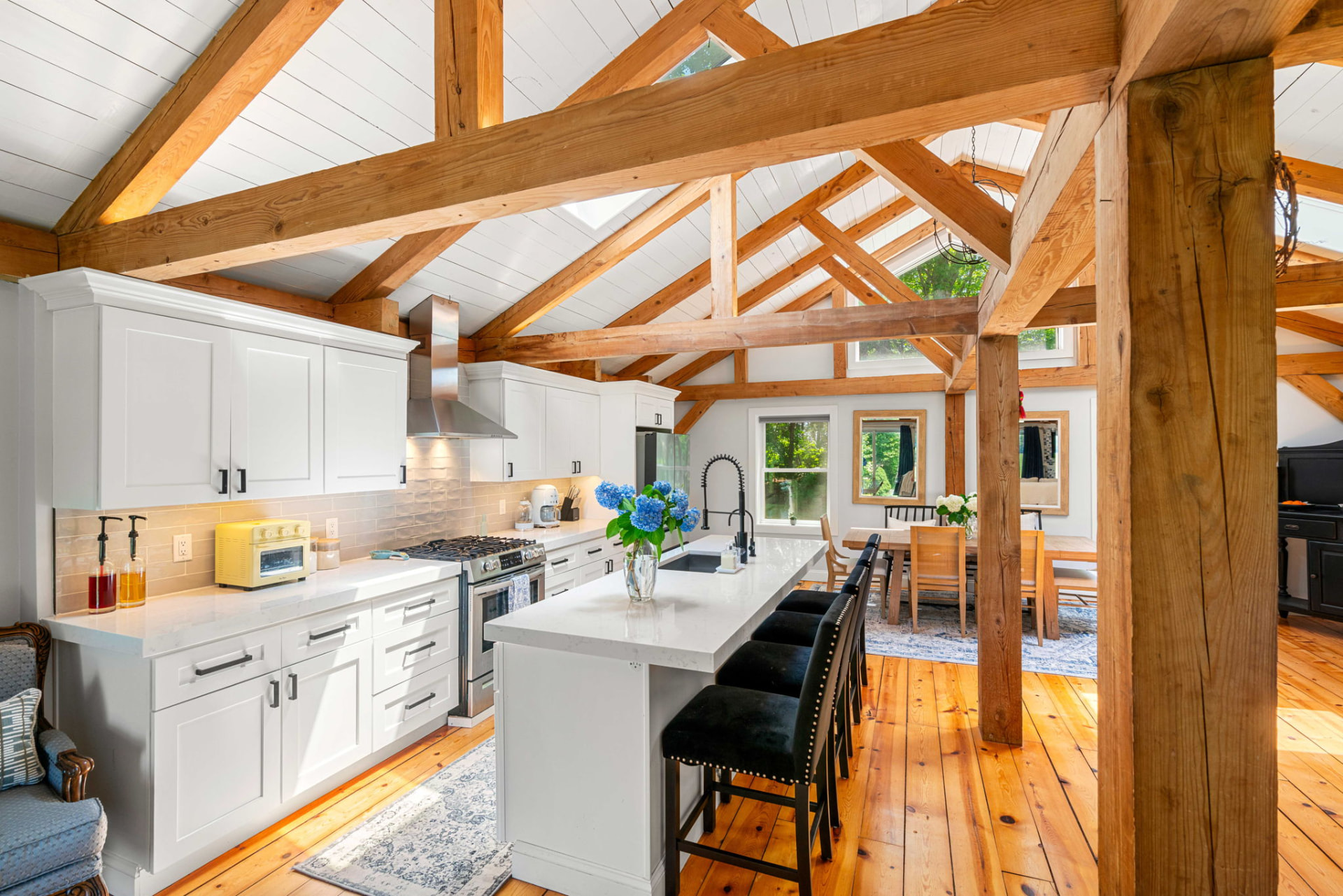 White shaker kitchen with quartz island and stainless range