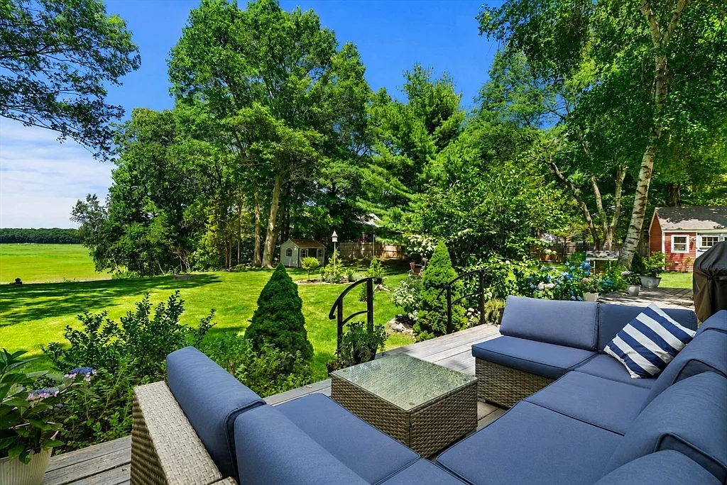 Deck lounge seating overlooking the lawn and open marsh